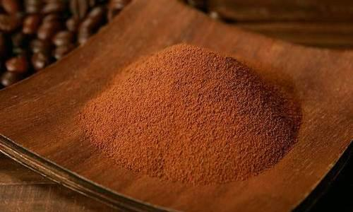 A slice of keto vanilla cake served on a white plate with a fork.