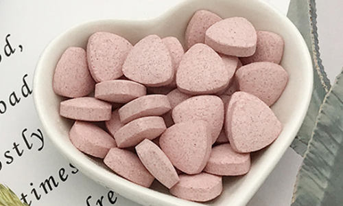 A slice of keto vanilla cake served on a white plate with a fork.