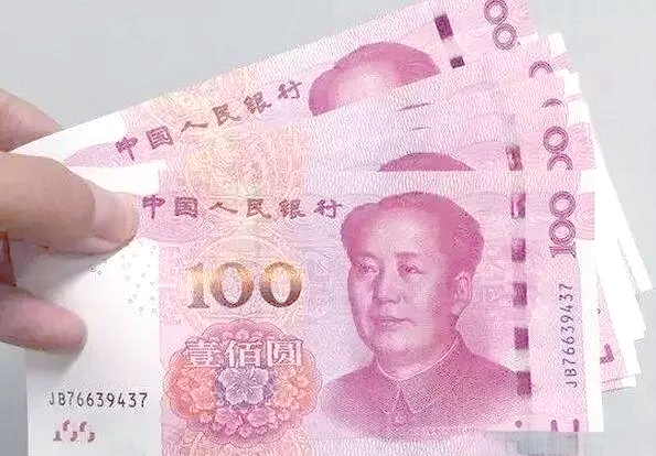 A slice of keto vanilla cake served on a white plate with a fork.